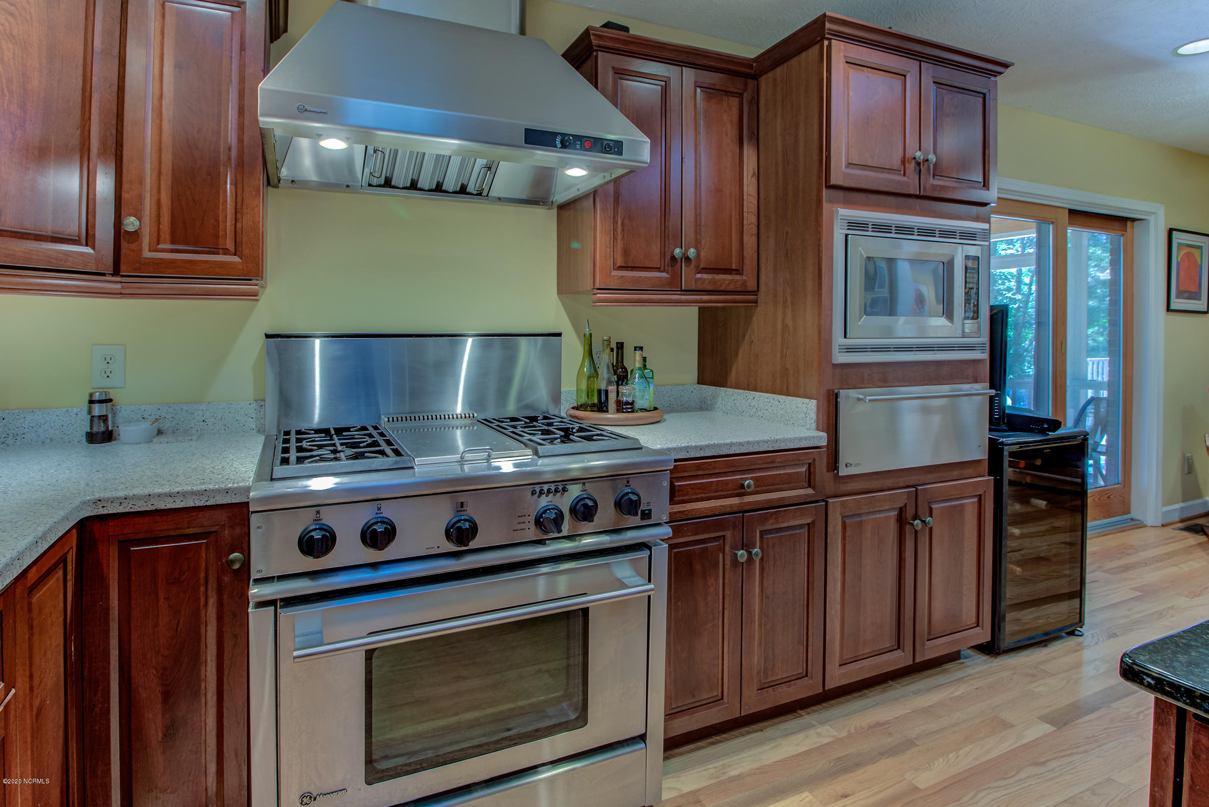 170 Goose Neck Road West Rocky Point, NC 28457 - Photo 12 of 46 GE Monogram oven, gas stove. GE Monogram Warming oven and GE Profile microwave set in Rich, cherry cabinets.