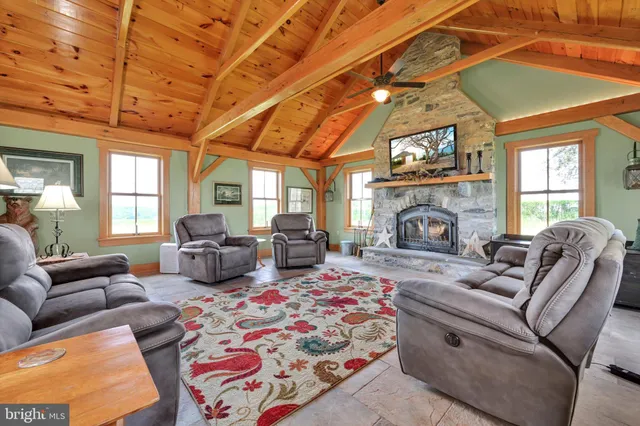 a view of the house with a big yard and large trees