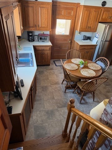 23 Nashua Street Ayer, MA 01432 - Photo 4 of 35 a kitchen with a table chairs and a refrigerator