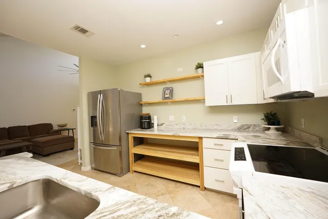 a kitchen with a sink a stove and refrigerator