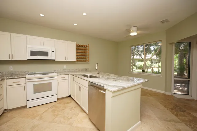 a kitchen that has a sink and a stove top oven