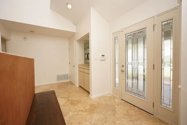 a view of a hallway with wooden floor and a cabinet