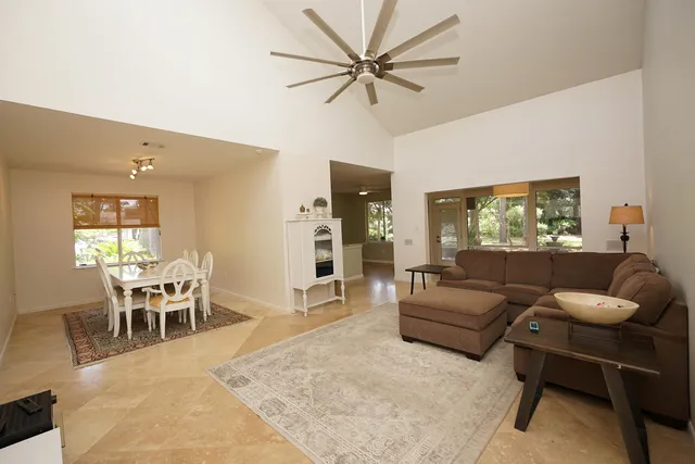 a living room with furniture a chandelier and a flat screen tv