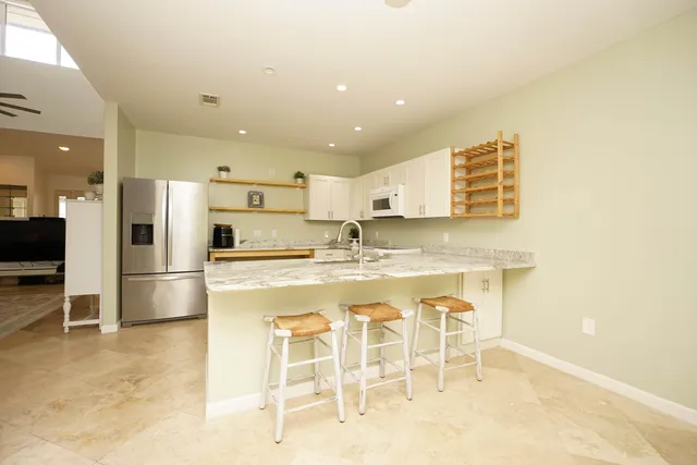 a kitchen with stainless steel appliances granite countertop a sink and cabinets