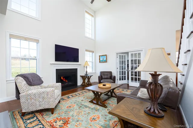 a living room with furniture a rug and a fireplace