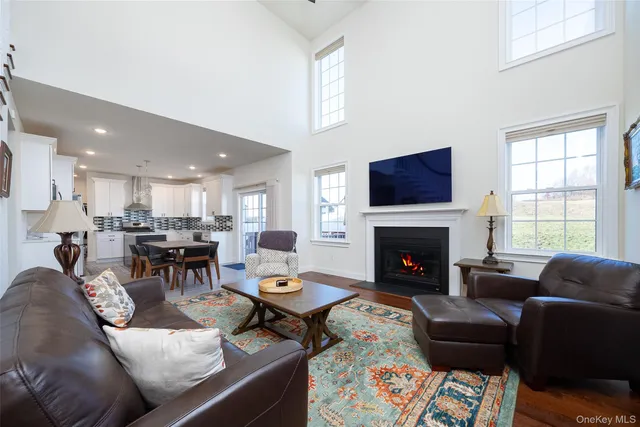 a living room with furniture fireplace and flat screen tv