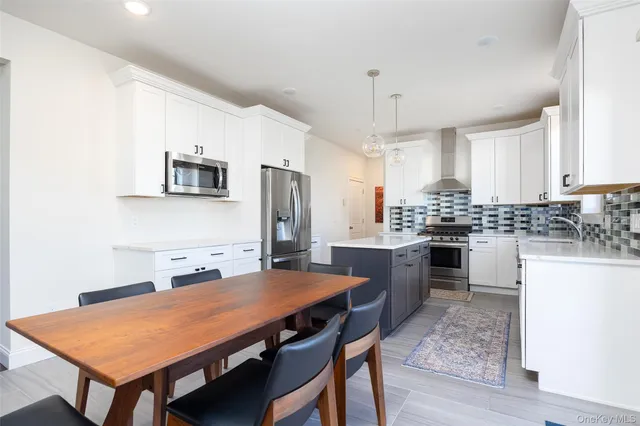 a kitchen with refrigerator cabinets and wooden floor