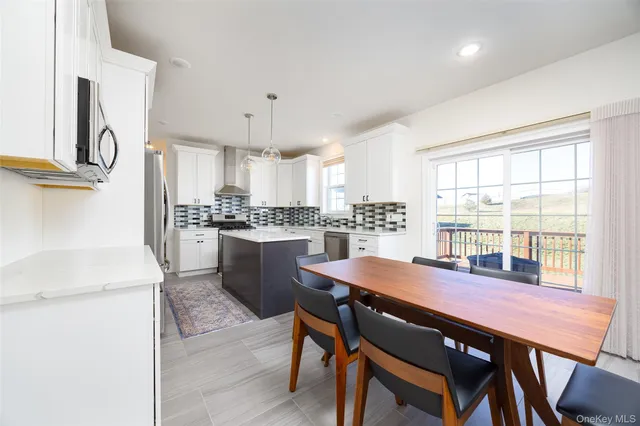 a kitchen with a dining table chairs and refrigerator
