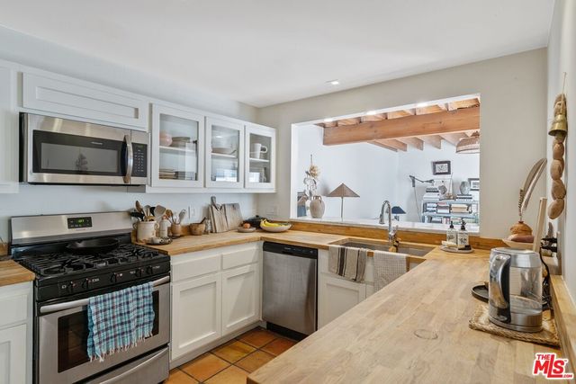 a kitchen with stainless steel appliances a sink stove and microwave