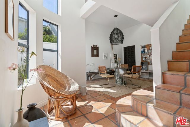 a view of a livingroom with furniture and a large window