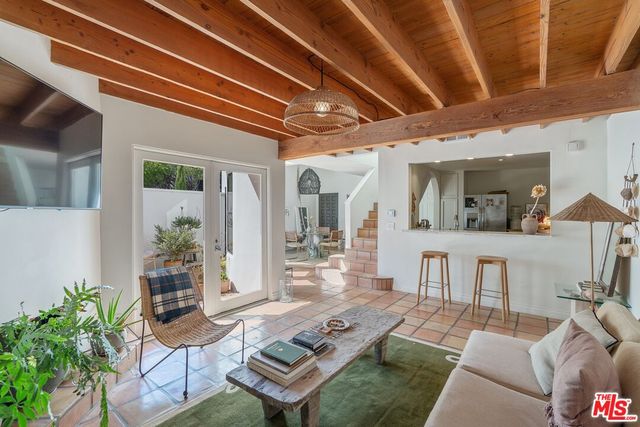 a living room with furniture and a dining table