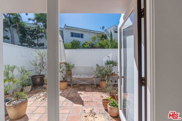 a view of a balcony with potted plants