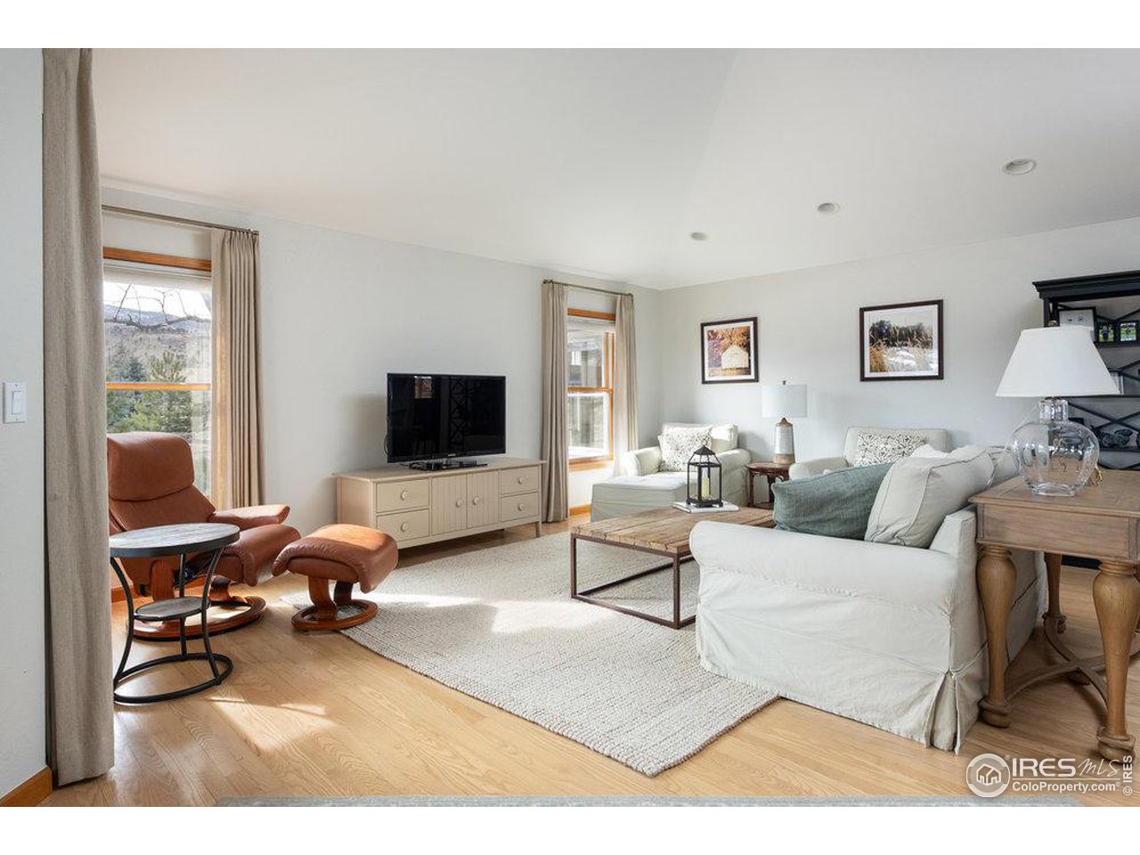 8923 Sage Valley Road Longmont, CO 80503 - Photo 18 of 40 a living room with furniture and a flat screen tv