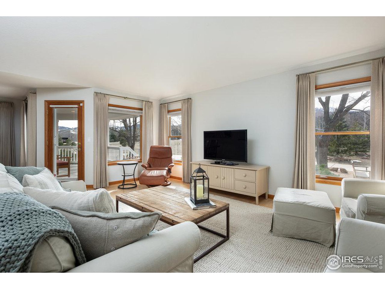 8923 Sage Valley Road Longmont, CO 80503 - Photo 19 of 40 a living room with furniture and a flat screen tv