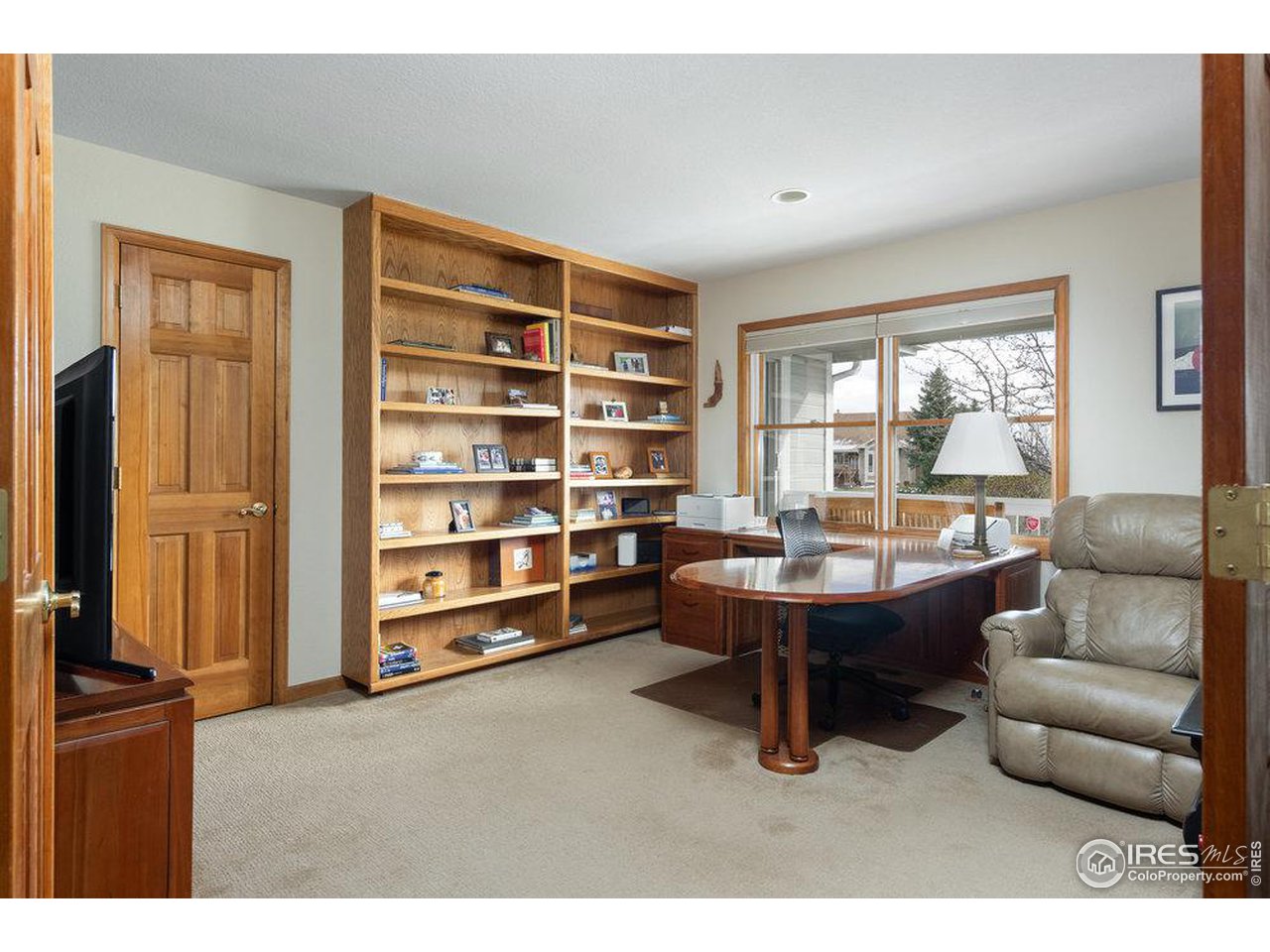 8923 Sage Valley Road Longmont, CO 80503 - Photo 22 of 40 a living room with furniture lamps and wooden floor