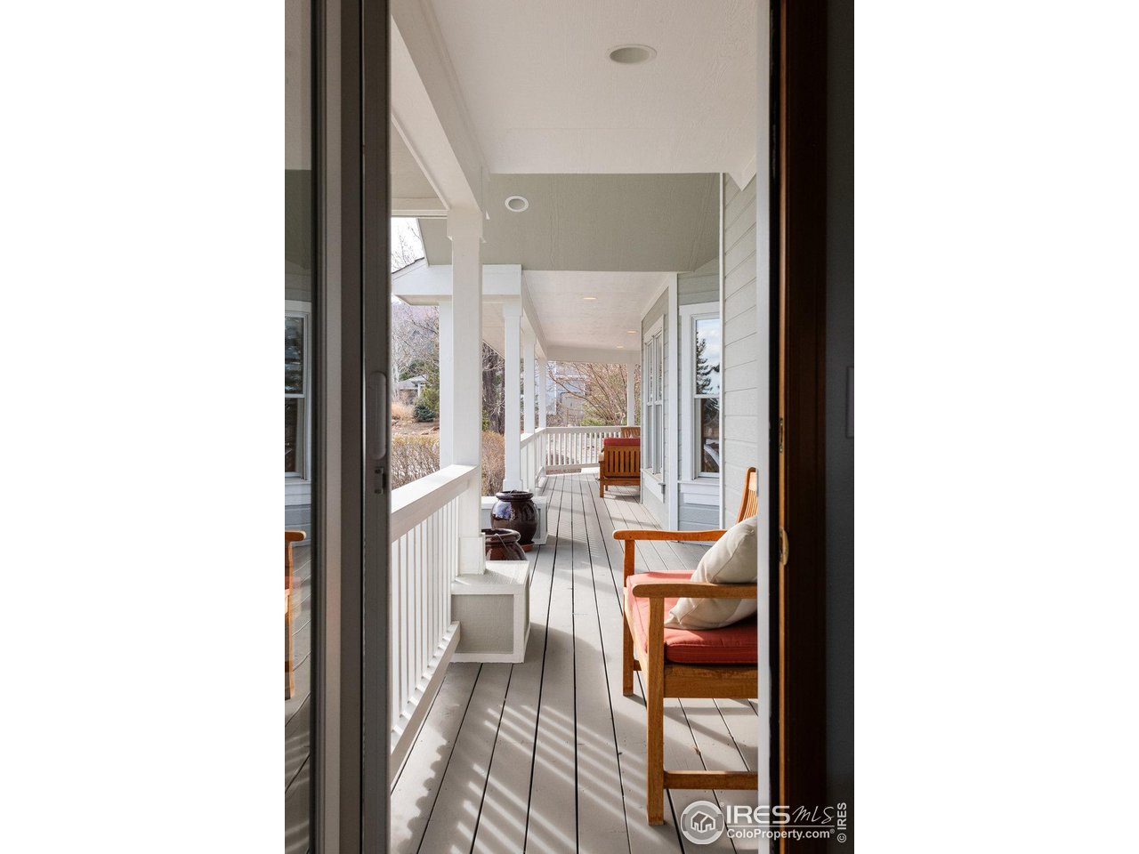 8923 Sage Valley Road Longmont, CO 80503 - Photo 27 of 40 a view of a hallway with wooden floor and furniture