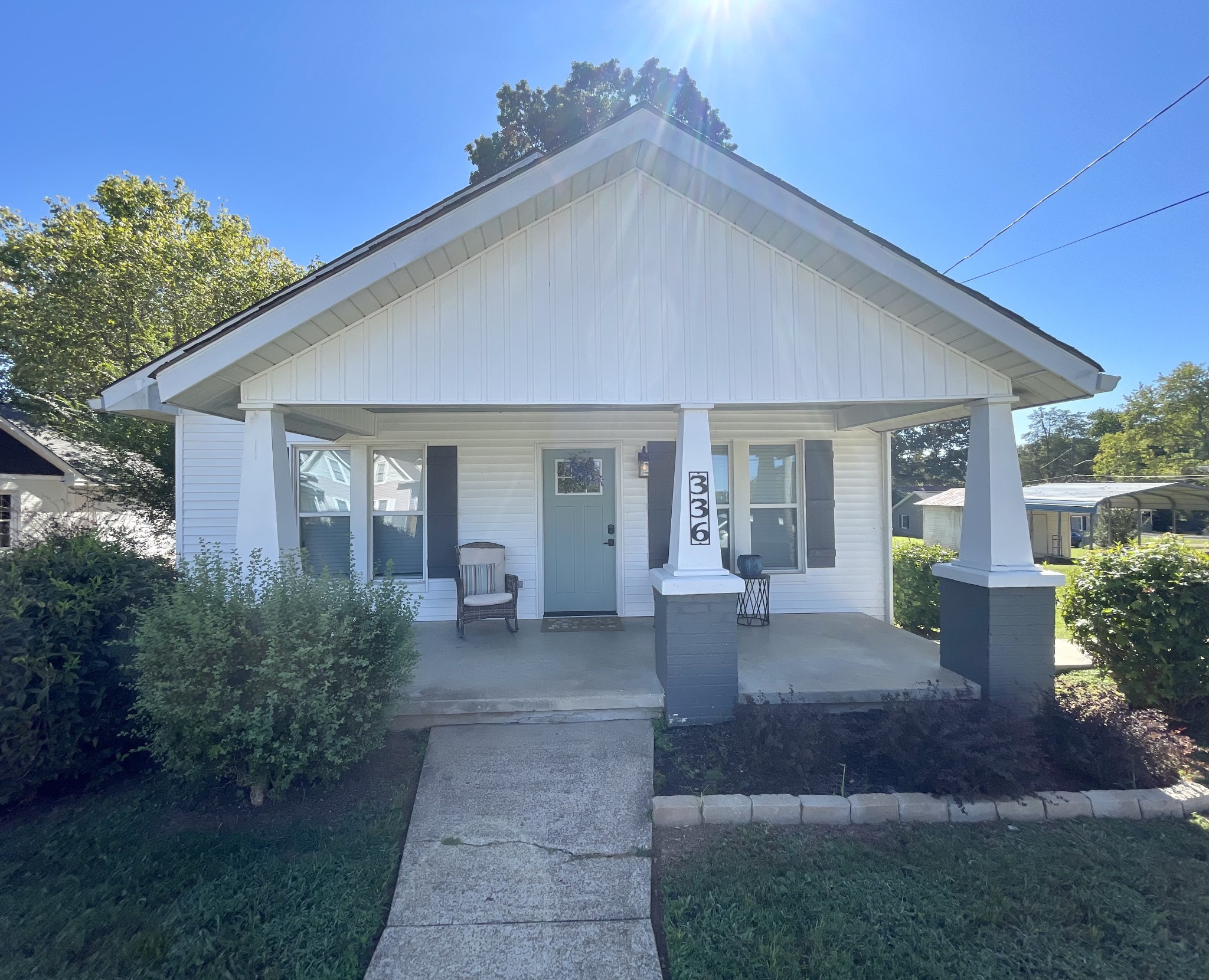 a front view of a house with garden and porch