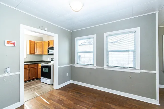 a kitchen with granite countertop wooden floors and stainless steel appliances