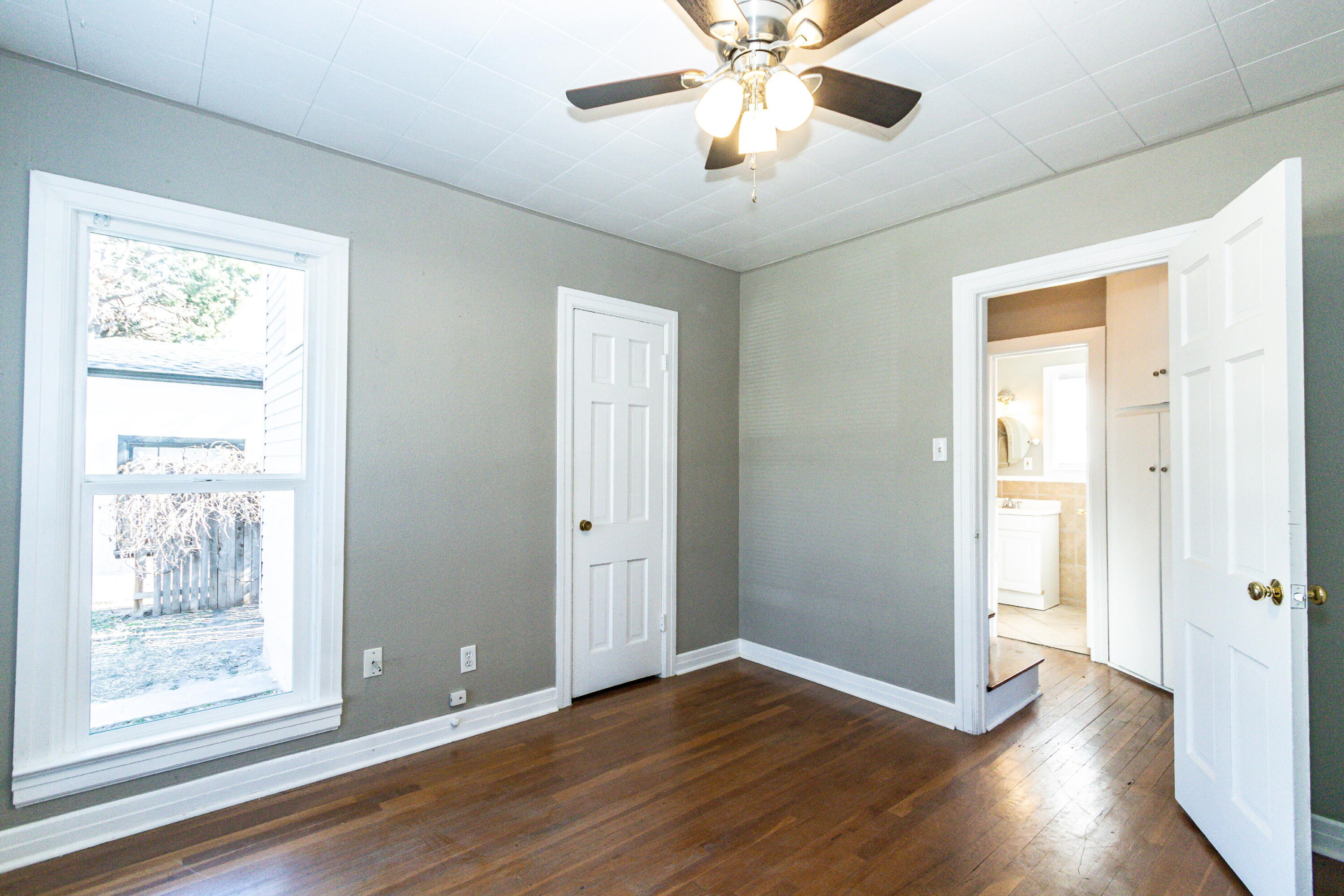 2417 25th Street Lubbock, TX 79411 - Photo 15 of 25 a view of an empty room with wooden floor and a window