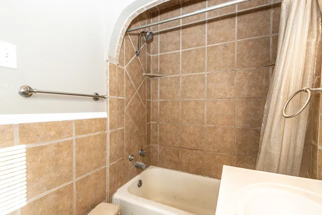 a bathroom with a bathtub and a shower