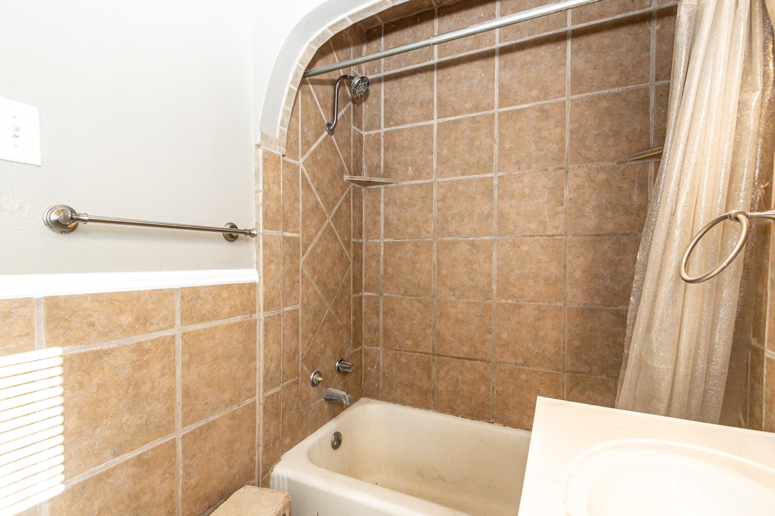 2417 25th Street Lubbock, TX 79411 - Photo 18 of 25 a bathroom with a bathtub and a shower