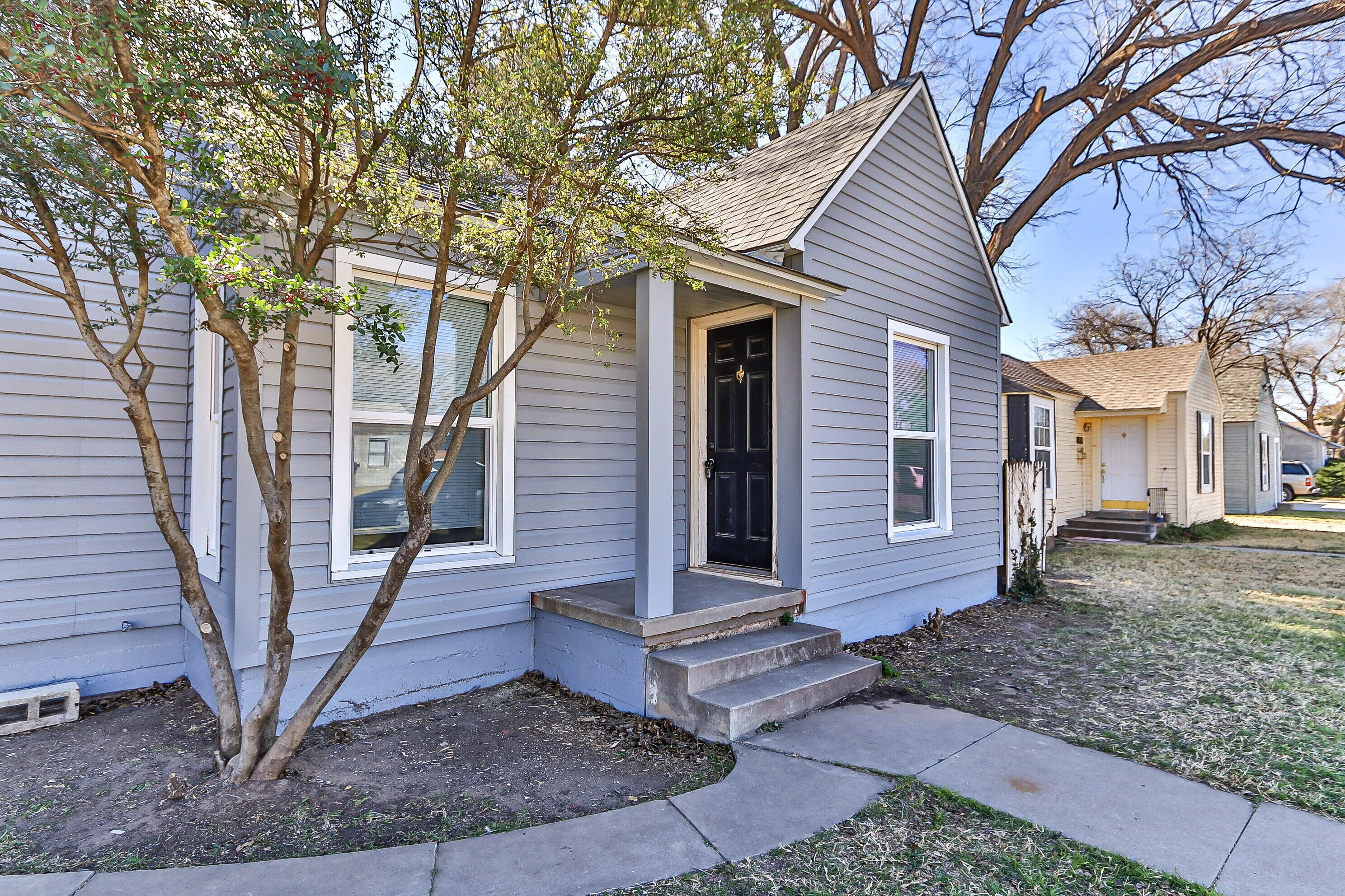 2417 25th Street Lubbock, TX 79411 - Photo 3 of 25 a view of a house with a yard and large tree