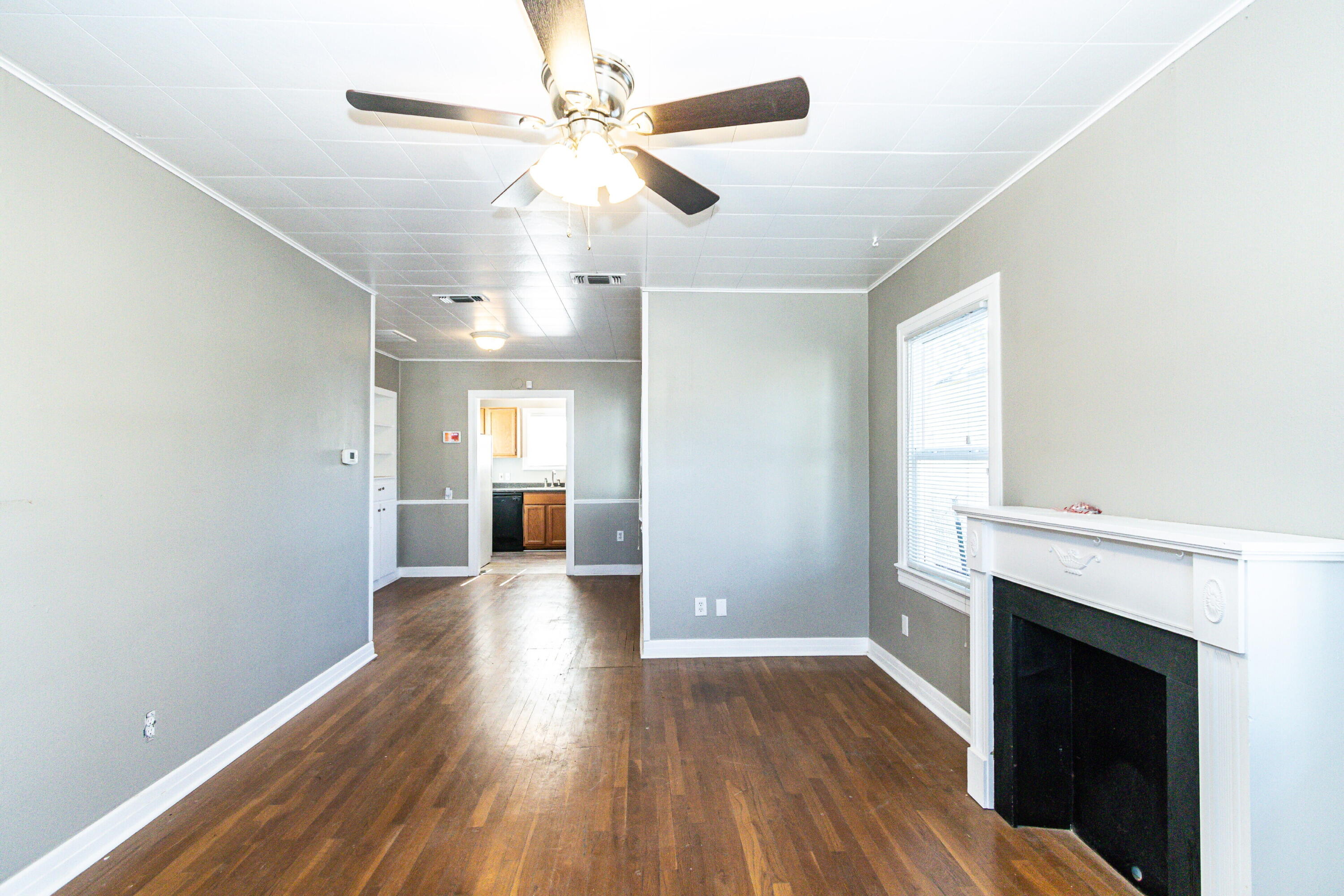 2417 25th Street Lubbock, TX 79411 - Photo 6 of 25 a view of a hallway with wooden floor and a fireplace