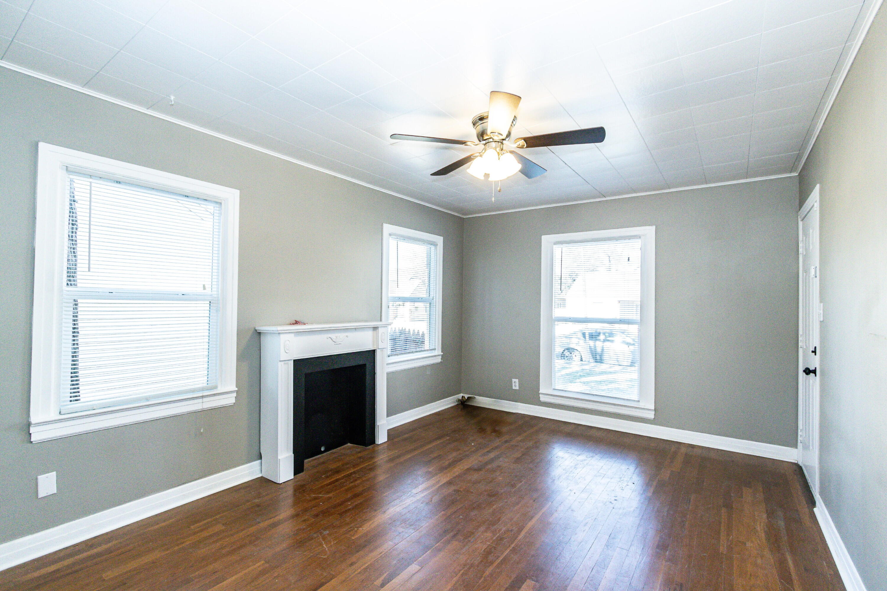 2417 25th Street Lubbock, TX 79411 - Photo 7 of 25 an empty room with wooden floor fan and windows