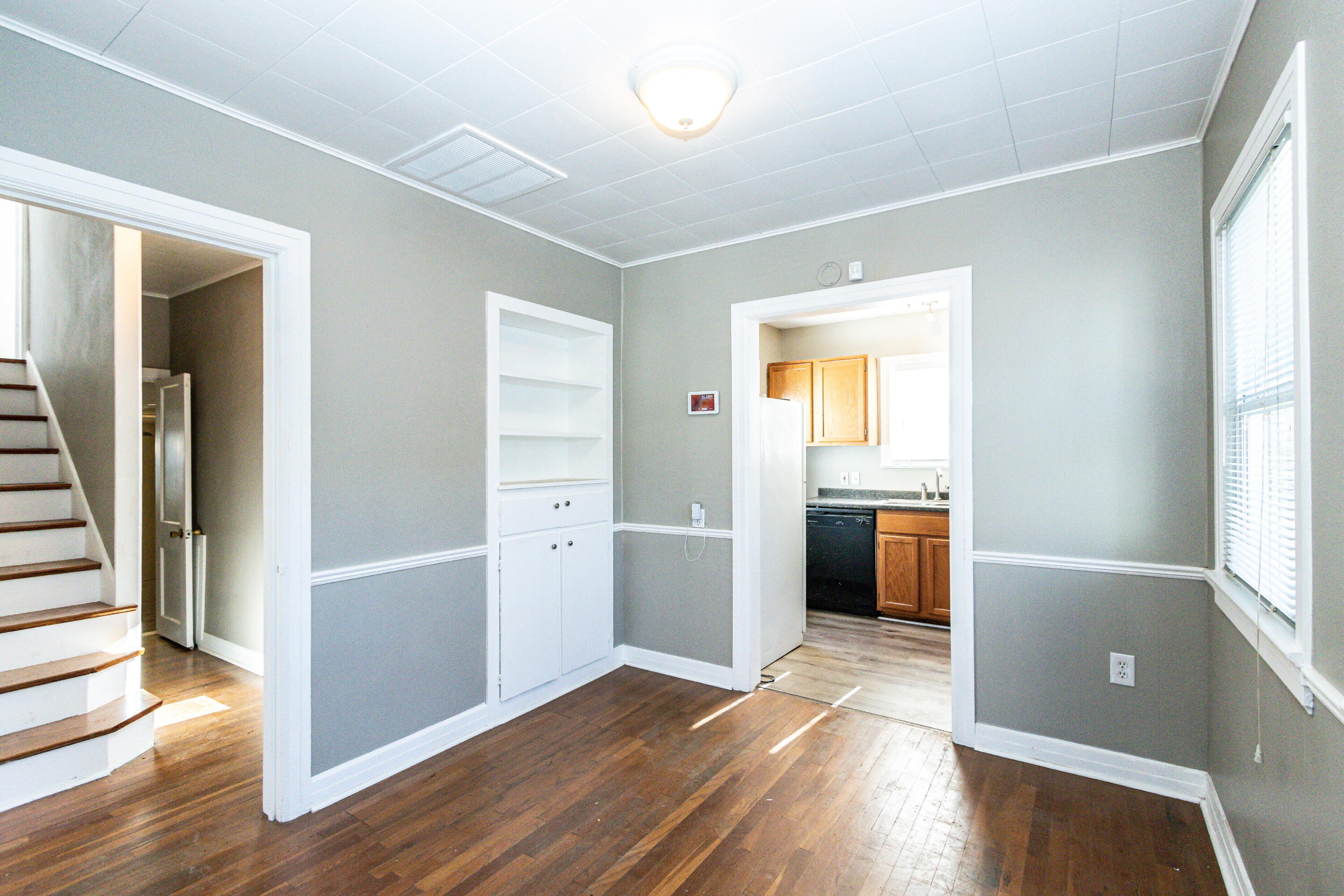 2417 25th Street Lubbock, TX 79411 - Photo 8 of 25 wooden floor in an empty room with a window