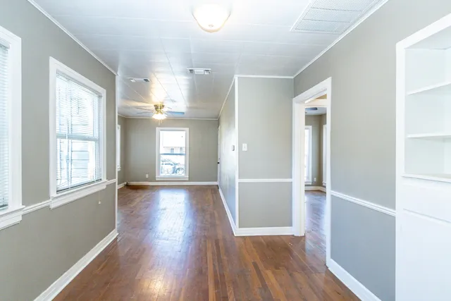wooden floor in an empty room with a window