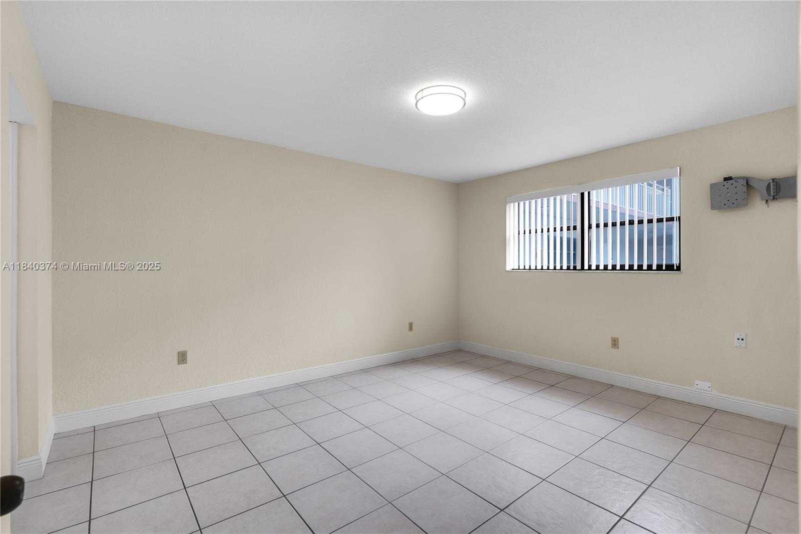 8425 Northwest 8th Street, Unit 304 Miami, FL 33126 - Photo 19 of 29 a view of an empty room with window