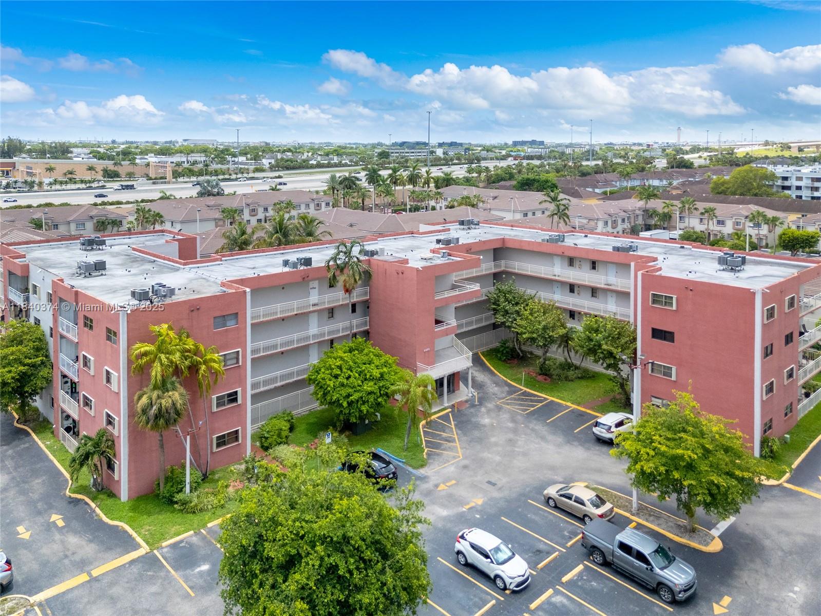 8425 Northwest 8th Street, Unit 304 Miami, FL 33126 - Photo 2 of 29 an aerial view of a house with a yard and lake view