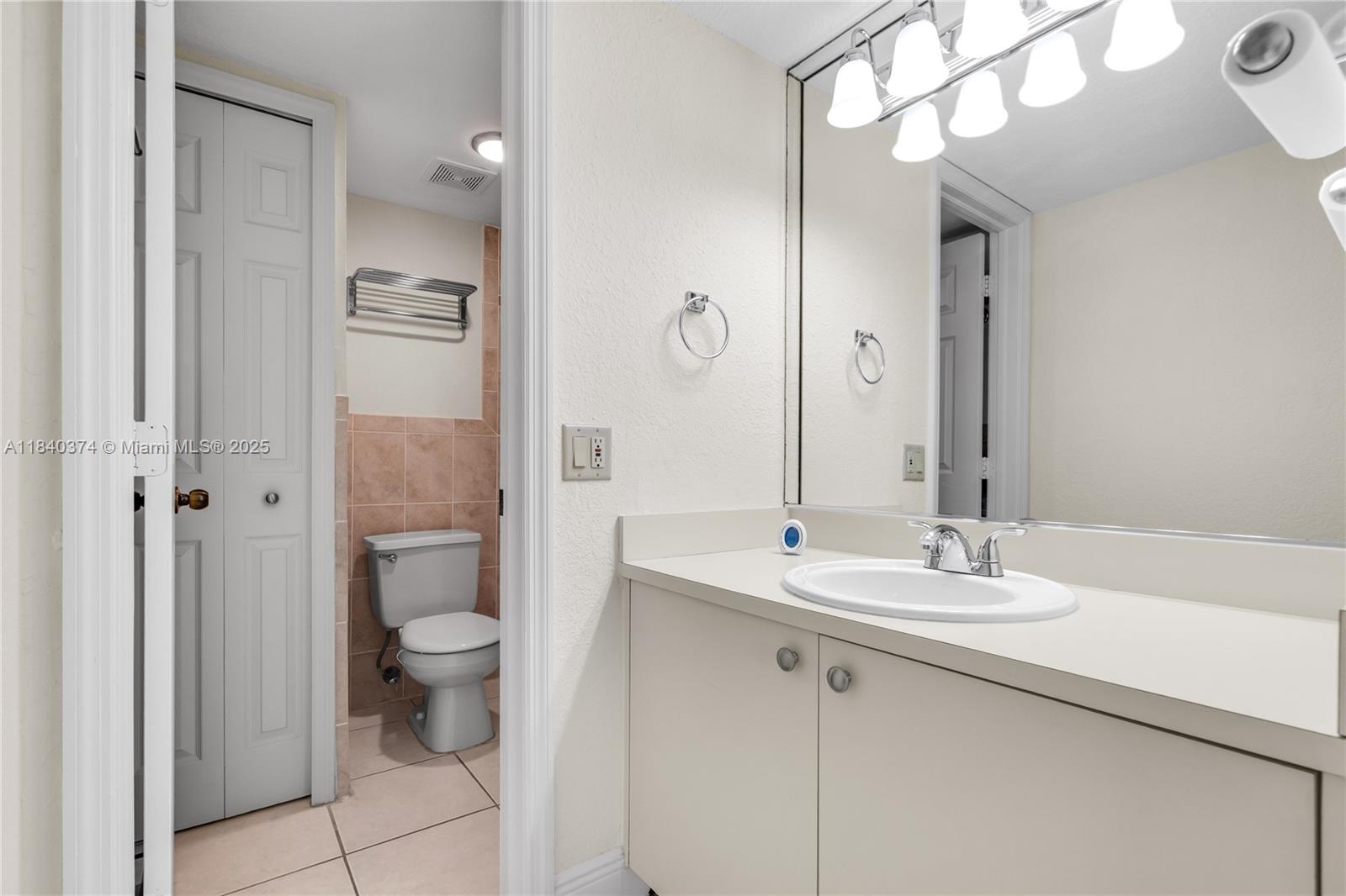 8425 Northwest 8th Street, Unit 304 Miami, FL 33126 - Photo 21 of 29 a bathroom with a sink a toilet and shower