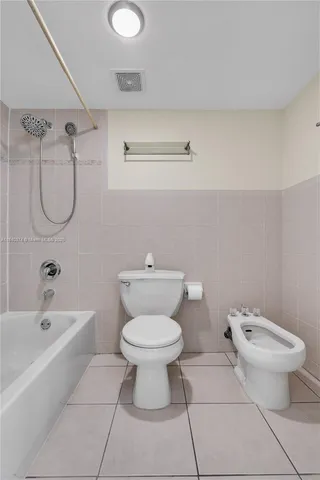 a bathroom with a toilet and a bathtub