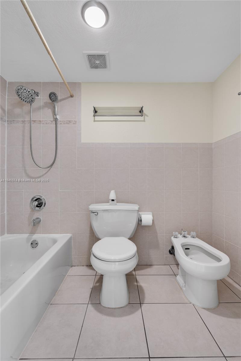 8425 Northwest 8th Street, Unit 304 Miami, FL 33126 - Photo 23 of 29 a bathroom with a toilet and a bathtub