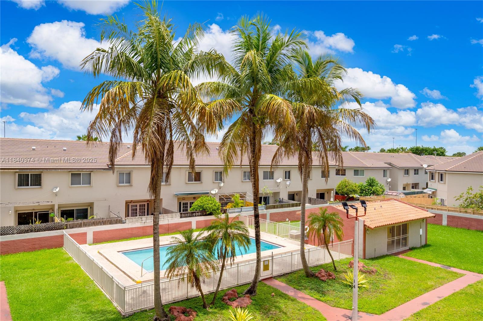 8425 Northwest 8th Street, Unit 304 Miami, FL 33126 - Photo 24 of 29 a swimming pool with outdoor seating and yard