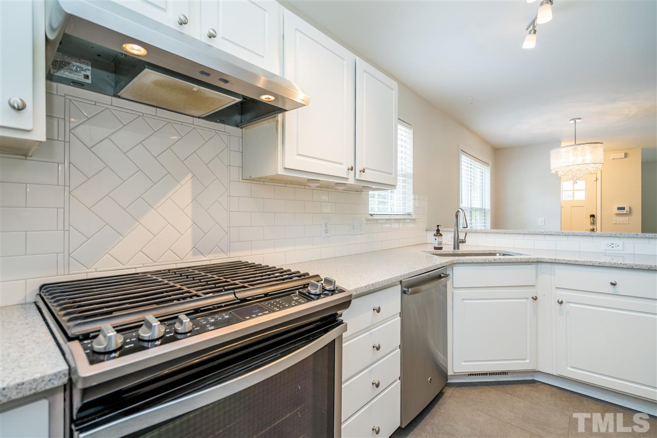 601 East Hargett Street Raleigh, NC 27601 - Photo 11 of 25 a kitchen with white cabinets and appliances