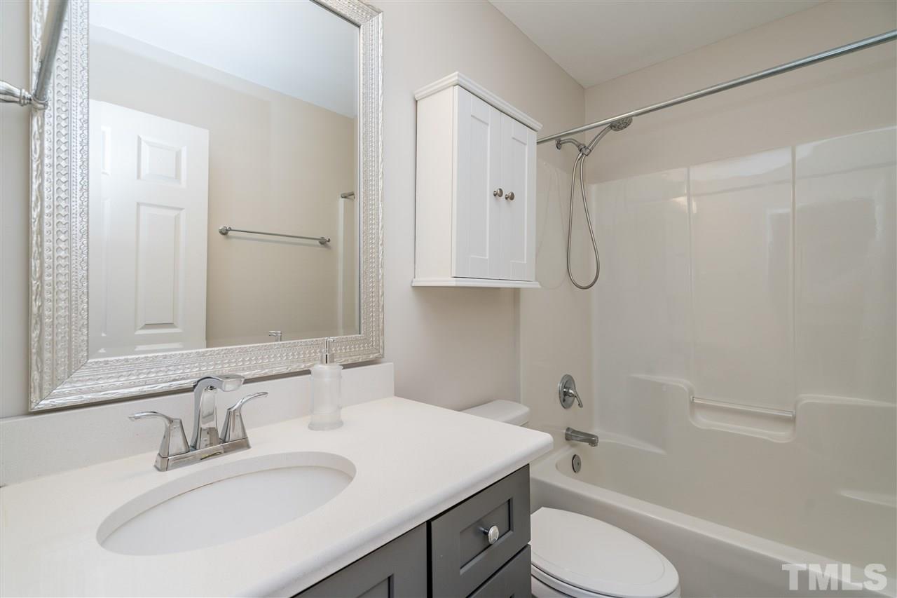 601 East Hargett Street Raleigh, NC 27601 - Photo 14 of 25 a bathroom with a sink toilet vanity and shower