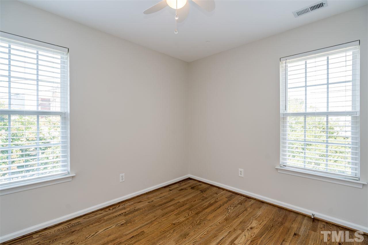 601 East Hargett Street Raleigh, NC 27601 - Photo 18 of 25 a view of an empty room with wooden floor and a window
