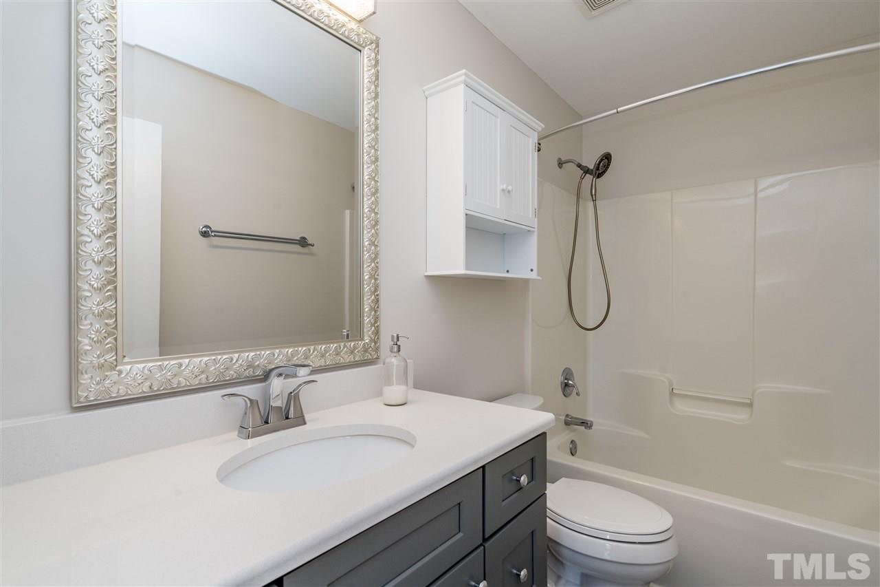 601 East Hargett Street Raleigh, NC 27601 - Photo 19 of 25 a bathroom with a sink toilet vanity and shower