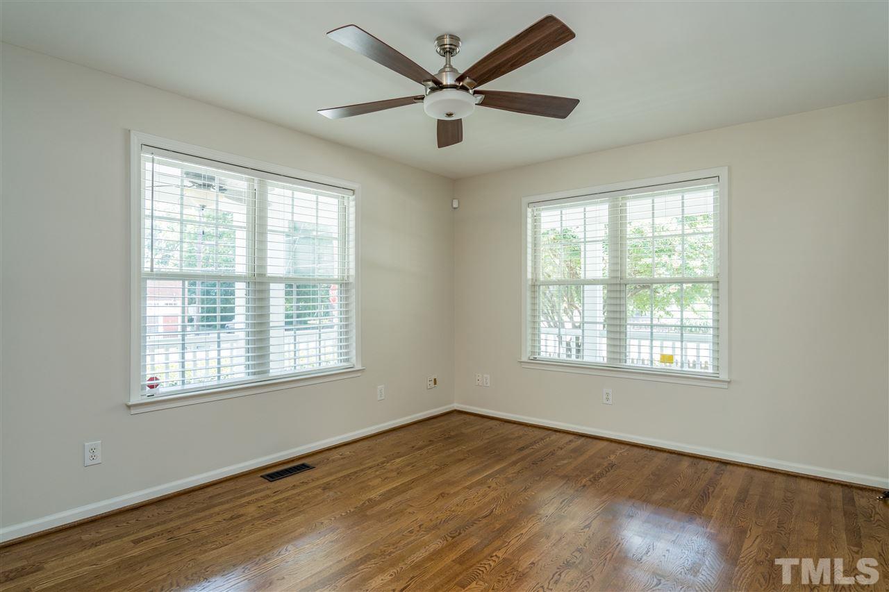 601 East Hargett Street Raleigh, NC 27601 - Photo 7 of 25 a view of an empty room with wooden floor and a window