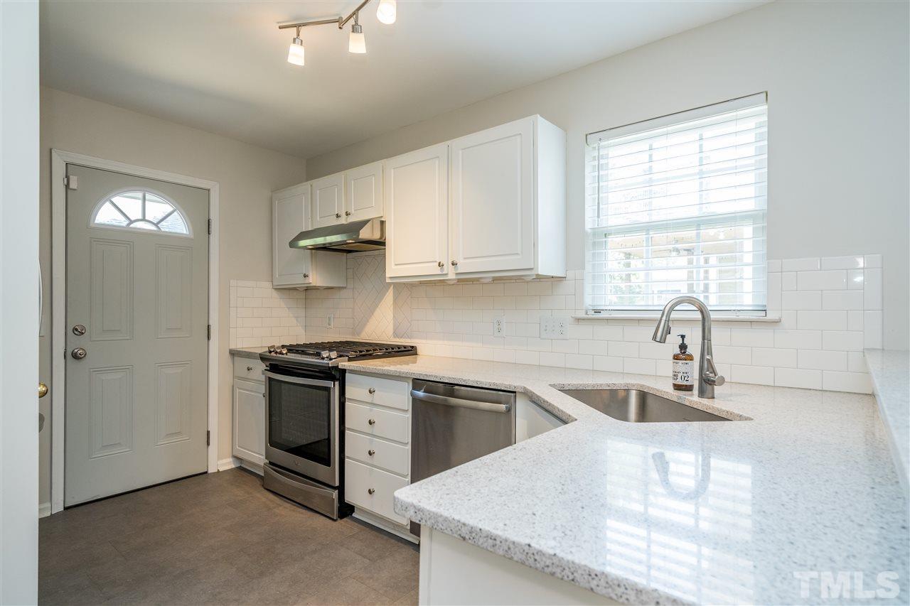 601 East Hargett Street Raleigh, NC 27601 - Photo 10 of 25 a kitchen with stainless steel appliances granite countertop a sink stove and refrigerator