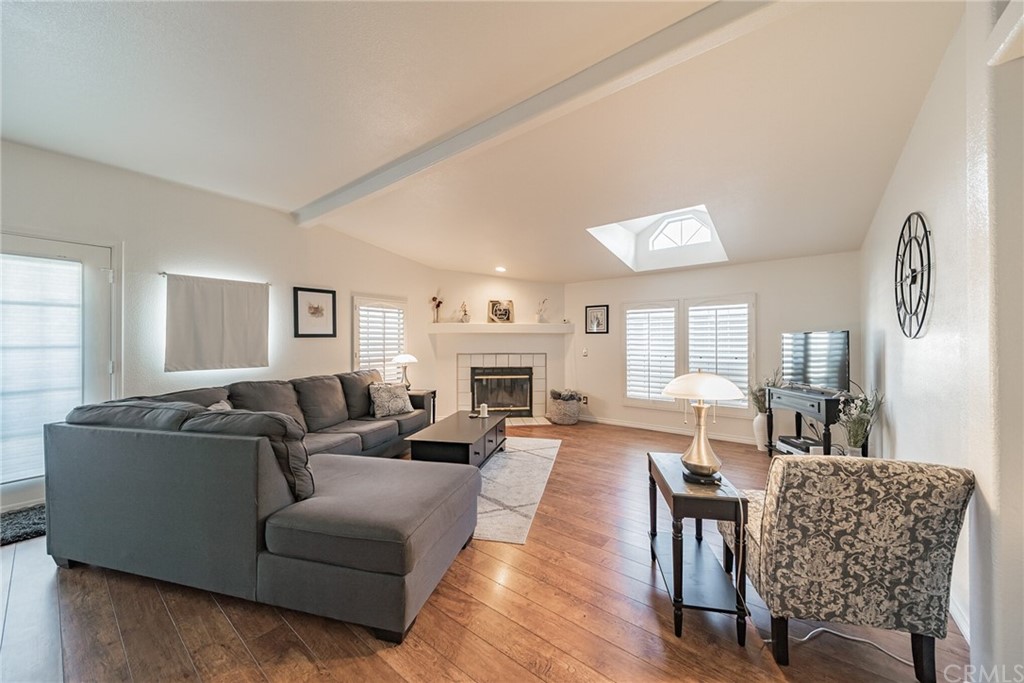 a living room with fireplace furniture and a wooden floor
