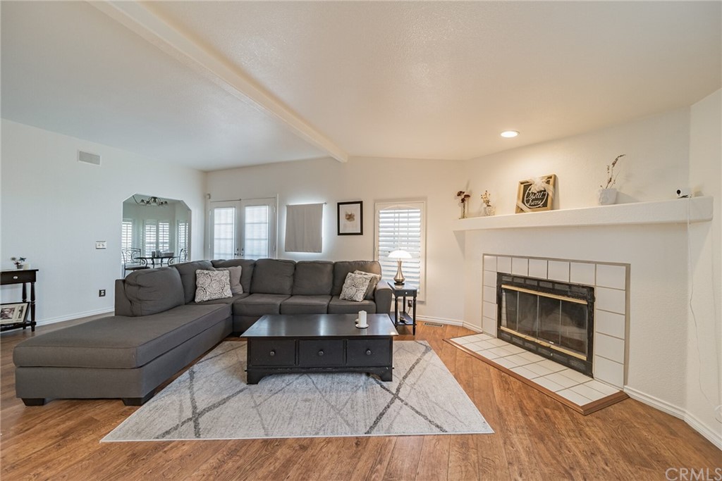 23301 Ridge Rte Drive, Unit 229 Laguna Hills, CA 92653 - Photo 2 of 26 a living room with furniture and a fireplace