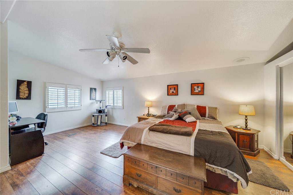 23301 Ridge Rte Drive, Unit 229 Laguna Hills, CA 92653 - Photo 13 of 26 a bedroom with a bed and wooden floor