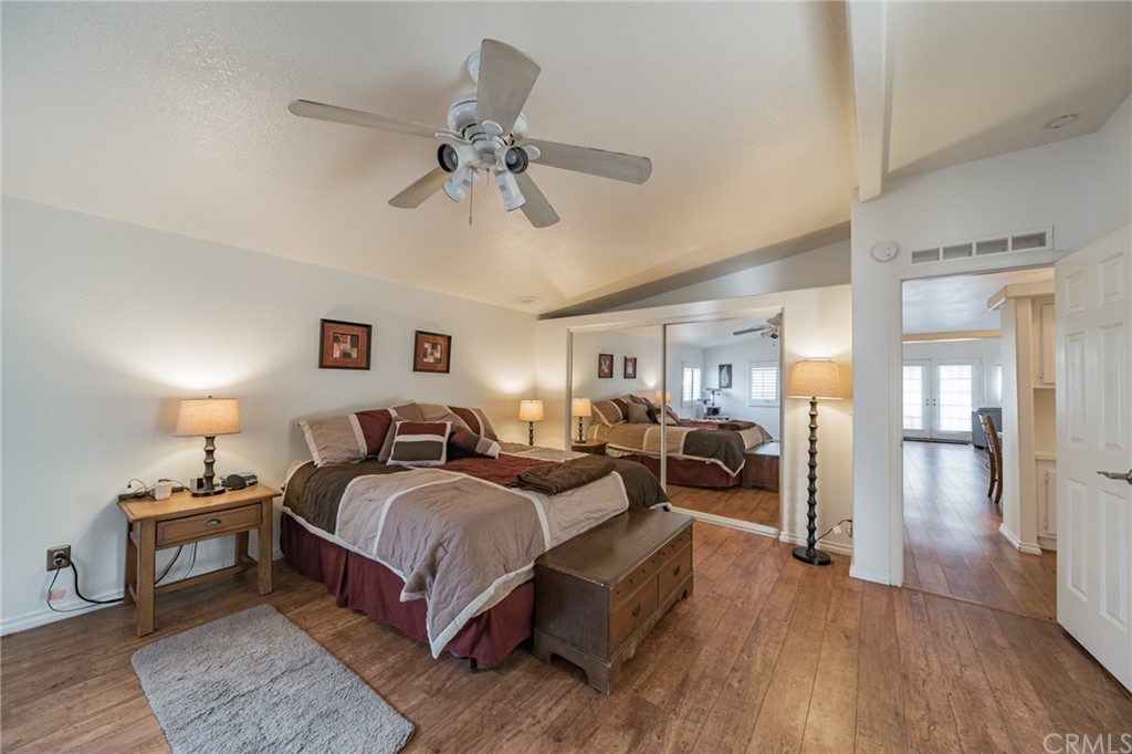 23301 Ridge Rte Drive, Unit 229 Laguna Hills, CA 92653 - Photo 14 of 26 a bedroom with a bed and wooden floor