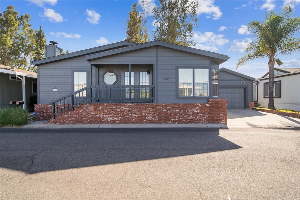 23301 Ridge Rte Drive, Unit 229 Laguna Hills, CA 92653 - Photo 20 of 26 a front view of a house with yard