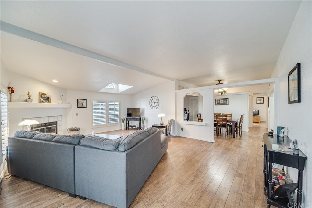 23301 Ridge Rte Drive, Unit 229 Laguna Hills, CA 92653 - Photo 3 of 26 a living room with furniture and wooden floor