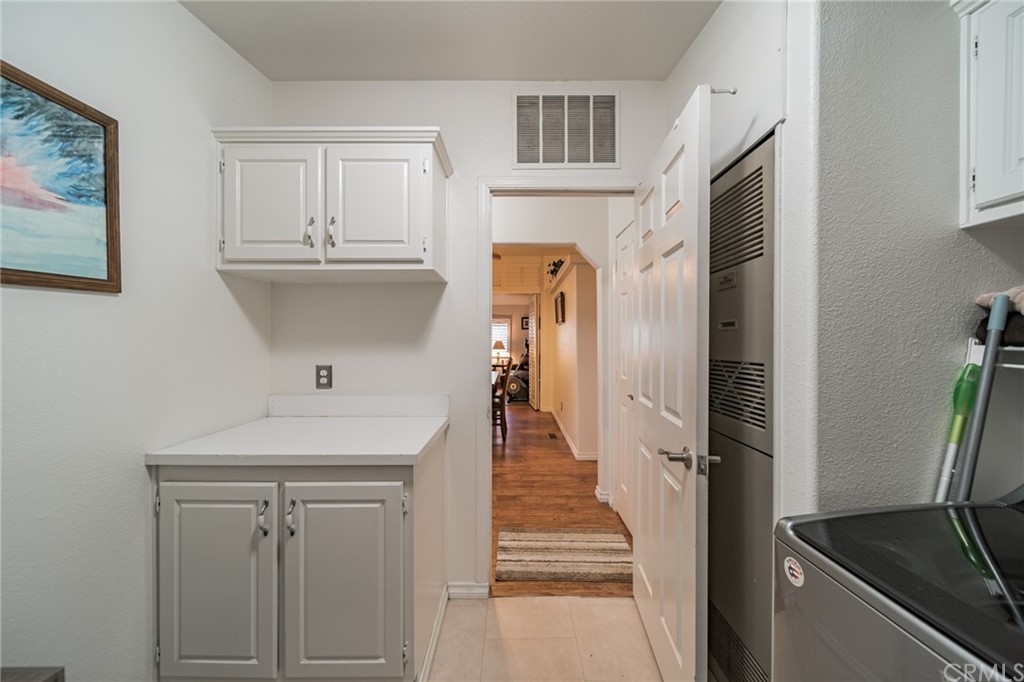 23301 Ridge Rte Drive, Unit 229 Laguna Hills, CA 92653 - Photo 23 of 26 a hallway with cabinets