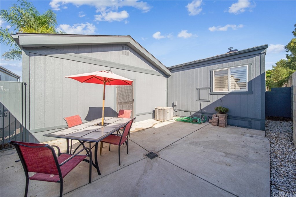 23301 Ridge Rte Drive, Unit 229 Laguna Hills, CA 92653 - Photo 24 of 26 a patio with a table and chairs under an umbrella